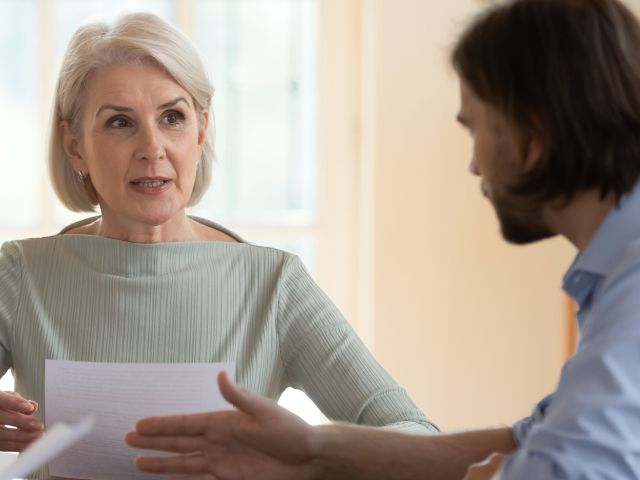 Mature woman discussing her will with her son