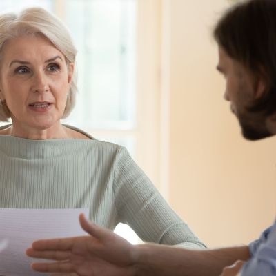 Mature woman discussing her will with her son